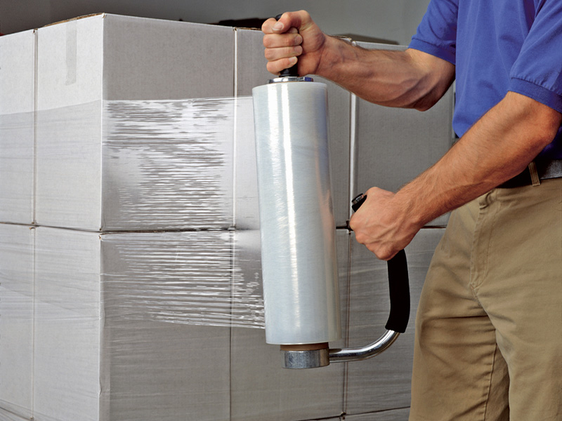 hand stretch film being applied to a box