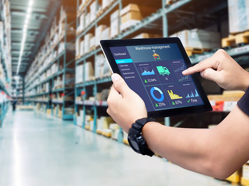 man holding a tablet forecasting packaging supplies needed for warehouse