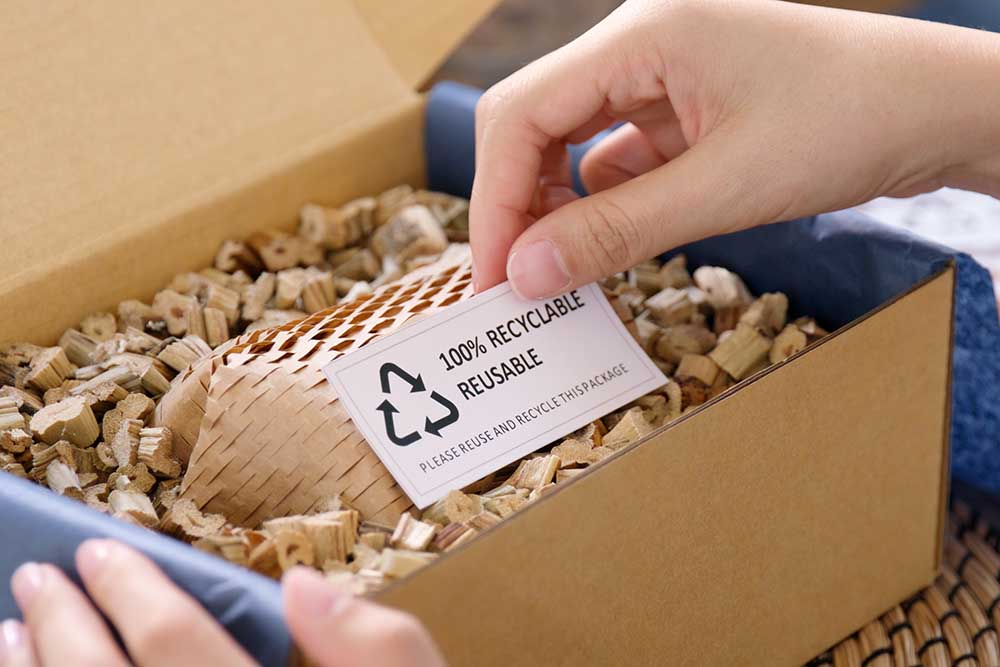 Eco vendor go green packaging parcel carton box in net zero waste store asian seller retail shop. Earth care day small SME owner asia people wrap reuse brown paper pack gift reduce plastic free order.